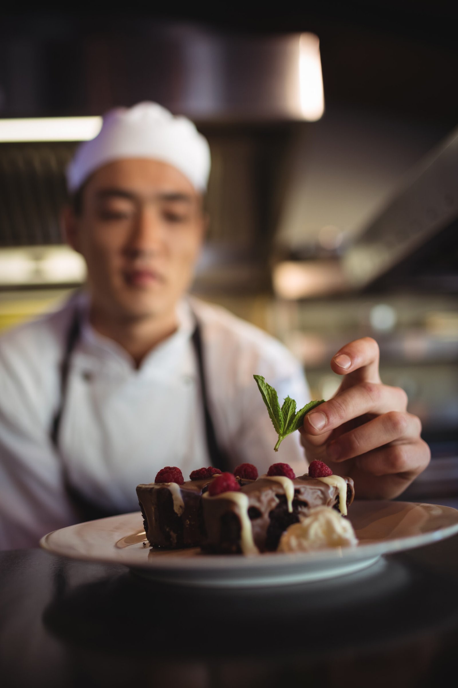 male chef garnishing dessert plate 2025 04 03 15 19 46 utc scaled